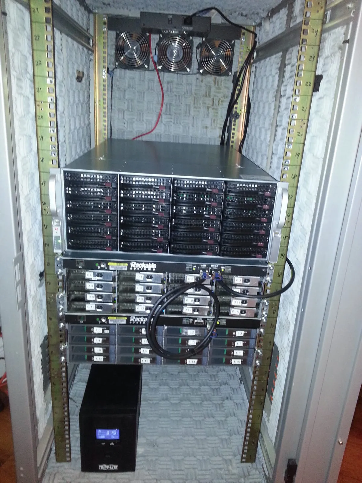 The SC846E16 and both Rackable SE3016s stacked in the rack, with the Tripp Lite UPS on the floor below